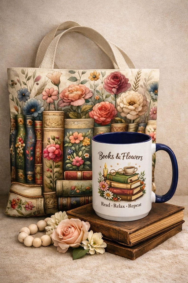 a handbag with a floral design, a blue mug with the text "Books & Flowers" and "Read - Relax - Repeat", a stack of books, and some flowers and beads on a table.