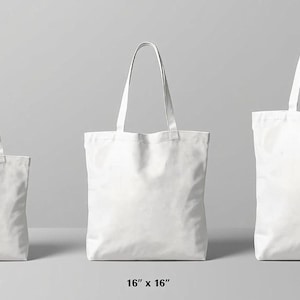 three white tote bags of different sizes, ranging from 33" to 18" in width.