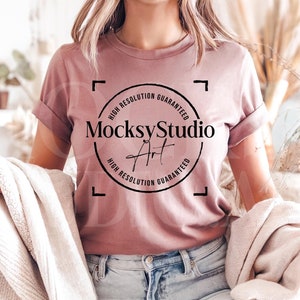 May include: A dusty rose t-shirt with a black circle graphic that says "MocksyStudio Art" with the text "High Resolution Guaranteed" around the circle.