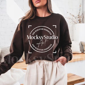 May include: A brown cropped sweatshirt with long sleeves and a white circle logo that says "MocksyStudio Art" with the text "High Resolution Guaranteed" around the circle.