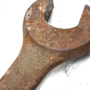 Vintage Solid Steel Wrench: Heavy Duty Farm Tool with Rustic Patina