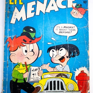May include: A vintage Li'l Menace comic book with a blue cover featuring a character in a green sheriff shirt holding a ticket pad that reads 'TICKETS 7¢ MUST PAY NOW!' next to a yellow car, a red fire hydrant, and a second character.