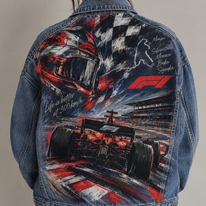 May include: A blue denim jacket featuring a large back graphic of a Formula 1 race car, a driver helmet, and a checkered flag. The print includes the text Life is better at 300km/h, the F1 logo, and a list of race track locations.