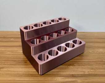 May include: A three-tiered rose gold lipstick organizer with 15 slots for storing lipstick tubes.
