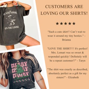 May include: Two dark gray t-shirts with graphic designs. One shirt features a goose wearing a cowboy hat with the text "Auntie Goose On The Loose." The other shirt has a Christmas tree design with the words "Merry Christmas."