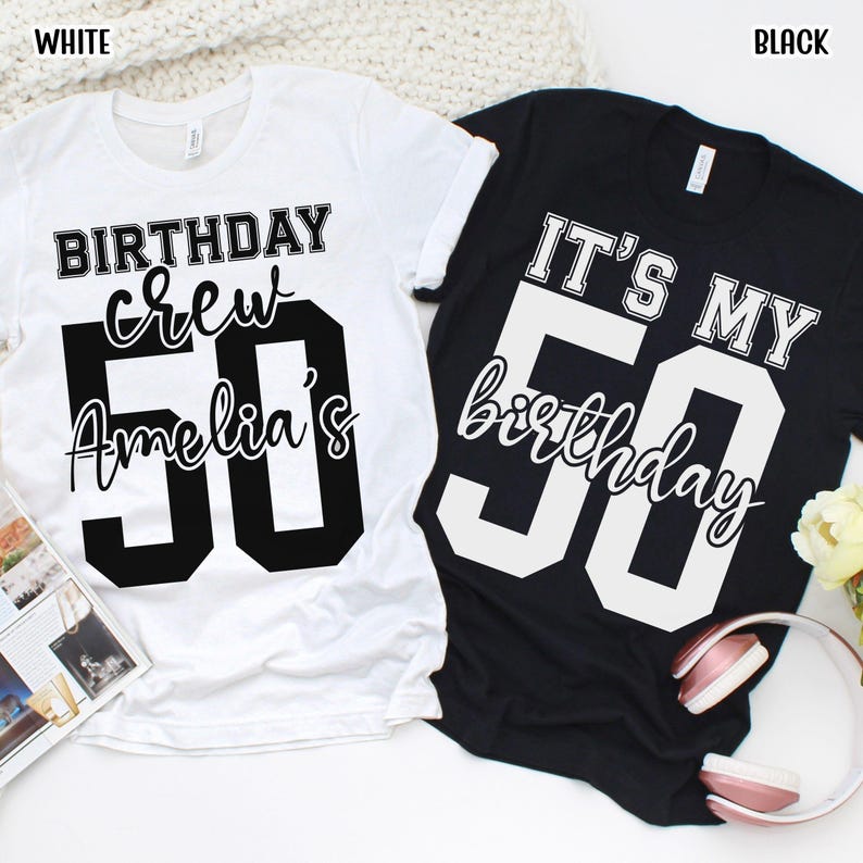 May include: A white t-shirt with black text reading BIRTHDAY crew Amelia's 50 and a black t-shirt with white text reading IT'S MY 50 birthday. Both shirts feature a crew neck, short sleeves, and large block-style numbers for the age 50.