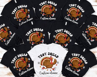 May include: A collection of black and white t-shirts with the text "TROT SQUAD" and a cartoon turkey wearing running shoes. The shirts have the option to add a custom name. The turkey design includes the year 2023.