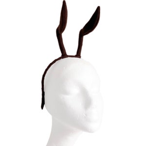 May include: A brown headband with two fuzzy brown bunny ears attached