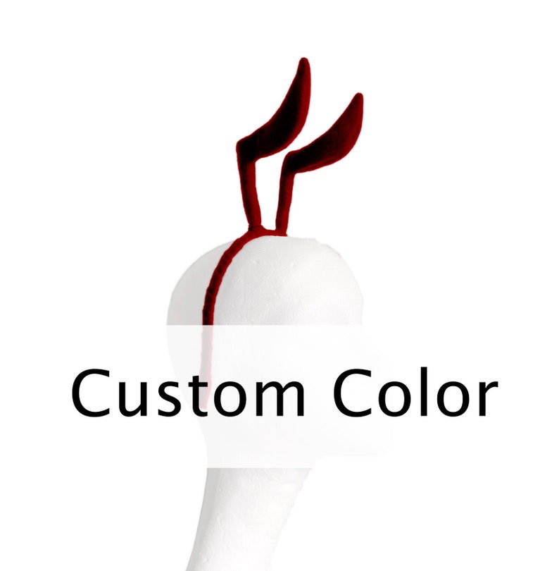 May include: Red felt bunny ears headband on a white mannequin head. The text 'Custom Color' is below the headband.