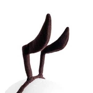 May include: A pair of brown fuzzy reindeer antlers headband