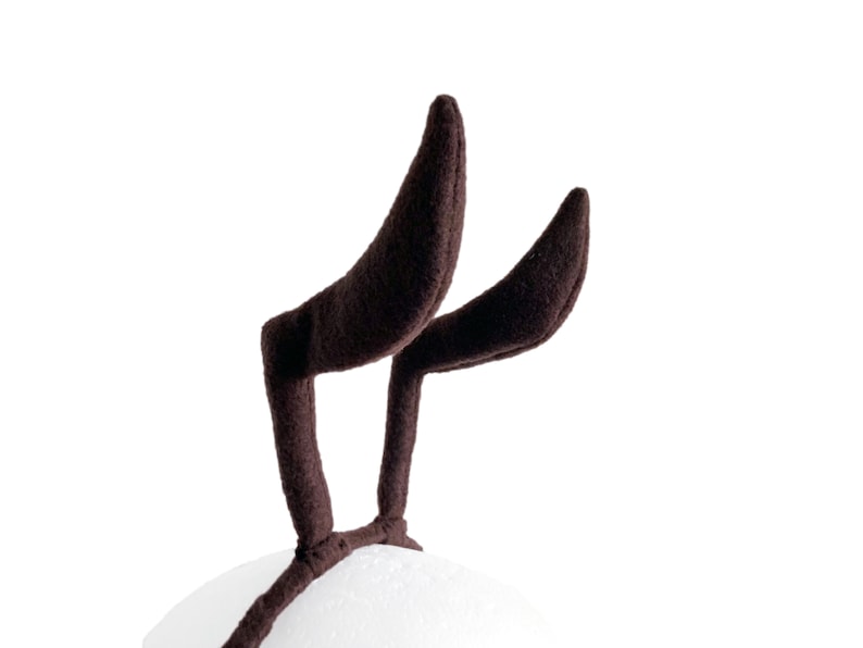 May include: A pair of brown fuzzy reindeer antlers headband