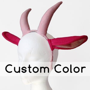 May include: Pink and red felt headband with two horns and ears.  The headband is designed to look like a goat or sheep.  Custom Color.