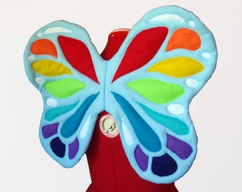 Ali di fata arcobaleno. Base azzurra, senza filo. Farfalla luminosa. Due misure. Design originale.