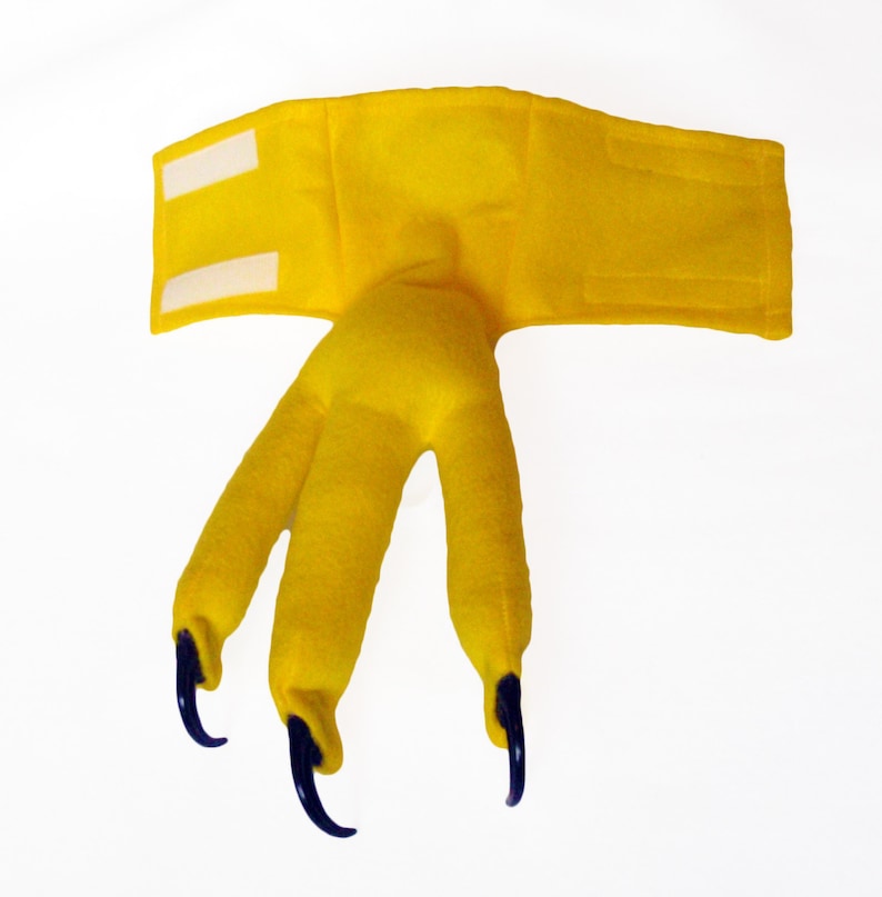 May include: Yellow felt claw costume with three claws and a headband with velcro closure.