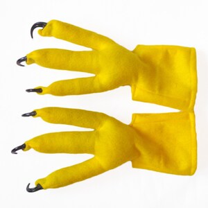 May include: A pair of yellow felt claw hand puppets with black plastic claws.
