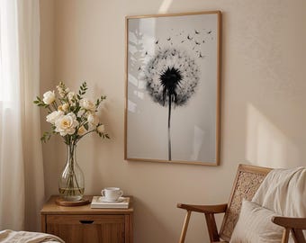 May include: A framed black and white dandelion art print hangs on a beige wall. The artwork features a detailed image of a dandelion seed head with some seeds floating away. A wooden nightstand with a vase of flowers, a cup, and a chair are in the foreground.