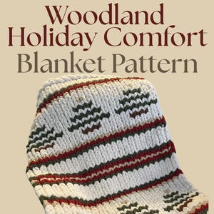 May include: A cream-coloured knitted blanket with a repeating pattern of green and brown tree-like shapes and red stripes. The blanket has the text "Woodland Holiday Comfort Blanket Pattern" in a dark red font.