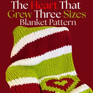 May include: A handmade blanket with a green, red, and white striped pattern and a red heart design. The blanket is made of a thick, textured yarn. The text "The Heart That Grew Three Sizes Blanket Pattern" is at the top.