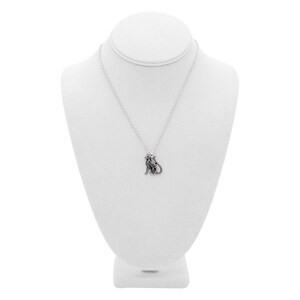 May include: A silver necklace with a small, detailed cat pendant. The necklace is displayed on a white mannequin bust.