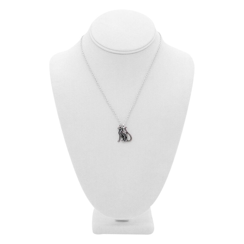 May include: A silver necklace with a small, detailed cat pendant. The necklace is displayed on a white mannequin bust.