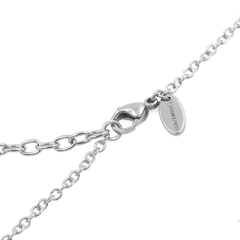May include: A silver chain necklace with a lobster clasp closure and a small silver tag with the text "ICONIQUE" engraved on it.