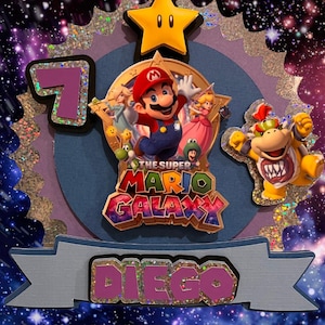 May include: A colorful birthday decoration featuring characters from the Super Mario Galaxy video game. The design includes a star, the number 7, and the name "Diego". The background is a starry night sky.