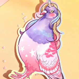 May include: A whimsical sticker featuring a pigeon with a unicorn horn and rainbow mane. The bird's body transitions from purple to pink, adorned with stars and heart-shaped patterns. The sticker is on a yellow background.
