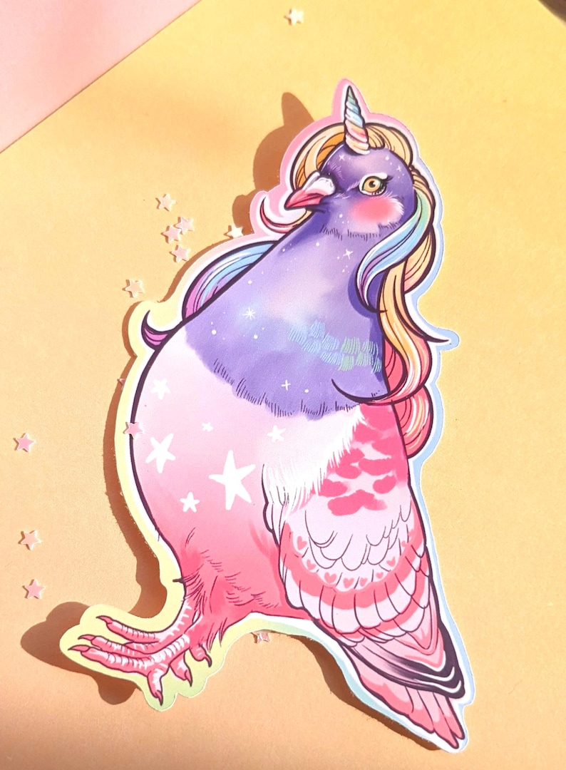 May include: A whimsical sticker featuring a pigeon with a unicorn horn and rainbow mane. The bird's body transitions from purple to pink, adorned with stars and heart-shaped patterns. The sticker is on a yellow background.