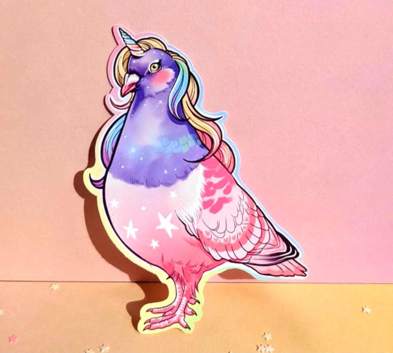 May include: A whimsical sticker featuring a pigeon with a unicorn horn and rainbow mane. The bird's body transitions from purple to pink, adorned with white stars and heart-shaped patterns. The sticker has a white border and is set against a pink background.