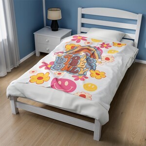 May include: White twin-sized bedspread with a colorful retro design featuring the text "Good Vibes Only" and smiley faces. The bedspread has a white background with yellow, orange, pink, and blue accents.