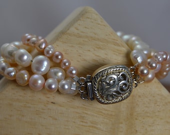 Three-strand Freshwater Pearl bracelet with elegant Sterling silver clasp. Bridal jewelry, pale pink, pale peach, June birthstone.