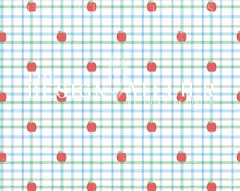May include: A repeating pattern of red apples on a blue and green plaid background. The words "DESIGN ATELIER BY ERIKA KENDRICK" are printed in white across the center of the image. The overall design is a whimsical, cheerful pattern.