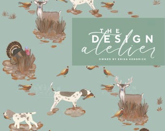 May include: A repeating pattern on a light green background features deer, turkeys, dogs, and pheasants. The dogs are spotted and carry birds in their mouths. The text "THE DESIGN atelier OWNED BY ERIKA KENDRICK" is in a green rectangle.
