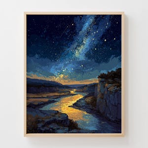 May include: A framed art print depicts a nighttime landscape with a river and a starry sky. The artwork features a river reflecting golden light, with dark cliffs on either side. The sky is a deep blue, filled with stars and a bright, glowing galaxy.