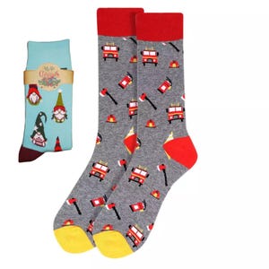 May include: A pair of grey socks with a red fire truck and axe pattern. A second pair of socks with a blue background and a gnome pattern is included. The gnome socks have the text "Merry Christmas" on them.