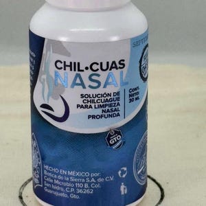 May include: A white and blue bottle of Chil-Cuas Nasal solution for deep nasal cleansing. The label includes text in Spanish, with the brand name prominently displayed. The bottle contains 30 ml of product and is made in Mexico.