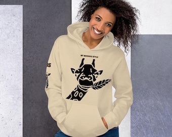 May include: A beige hoodie with a black giraffe graphic and the text "MY BOOHOO STYLE" on the front. The hoodie has a drawstring hood and a kangaroo pocket.