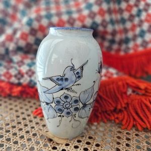 Vintage pottery vase with painted bluebird