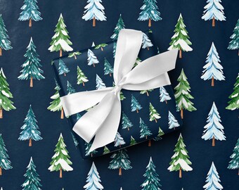 Papel de regalo con árbol nevado en invierno