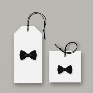 May include: Two white gift tags featuring black bow tie designs. One tag is rectangular, the other square. Both have black string attached for hanging. The bow ties are centered on the tags against a grey background.
