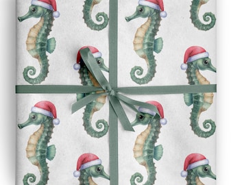 May include: Wrapping paper featuring a repeating pattern of green seahorses wearing red and white Santa hats on a light gray background, tied with a dark green ribbon. The seahorses are depicted in a watercolor style with detailed textures.