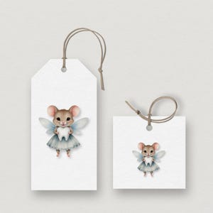 May include: Two white gift tags with a watercolor illustration of a mouse dressed as a tooth fairy. The mouse has pink ears, blue wings, and a blue dress, holding a tooth. The tags have brown string.