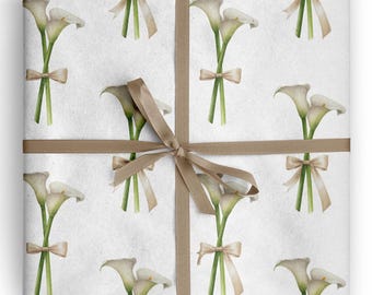 May include: White wrapping paper featuring a repeating pattern of watercolor calla lilies with green stems and beige bows. A brown ribbon is tied around the paper in a cross pattern, creating a gift-wrapped appearance.