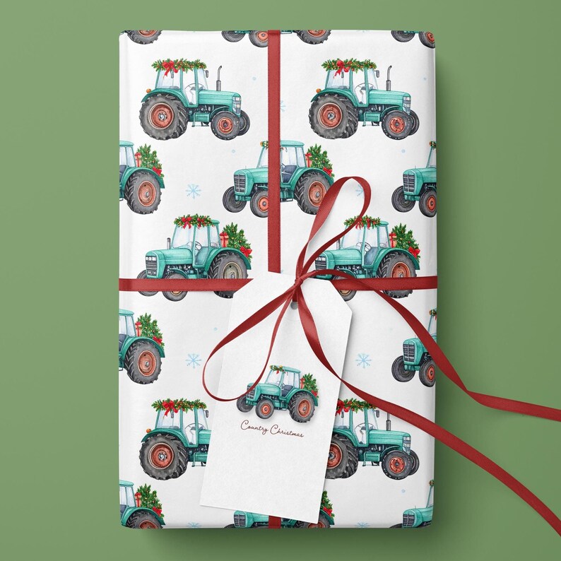 May include: White wrapping paper with a repeating pattern of teal tractors decorated for Christmas. The gift is tied with a red ribbon and a tag that reads "Country Christmas". The tractors have red and green accents.