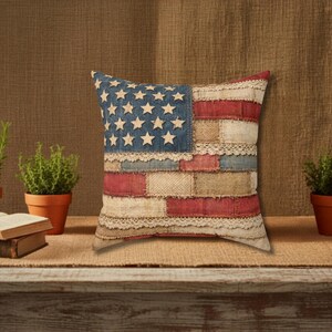 Rustic patriotic pillow with vintage American flag patchwork design on wood shelf with plants and books