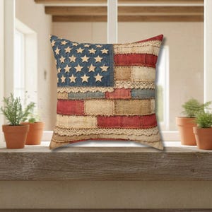 Patriotic patchwork American flag throw pillow styled on wood surface with rustic decor and neutral tones