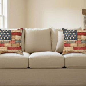 American flag patchwork farmhouse pillow displayed on neutral couch in cozy living room setting