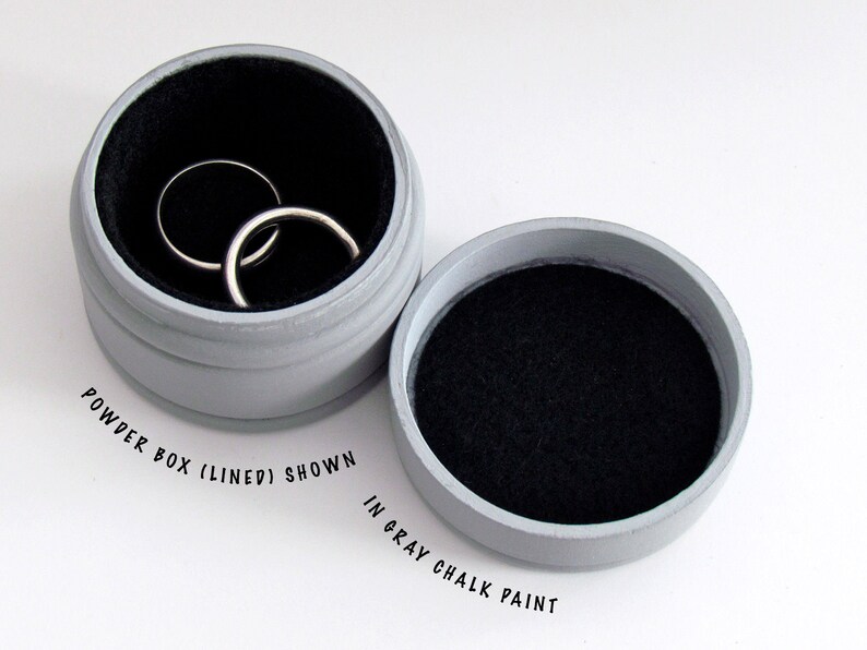 May include: A gray, round powder box with a black interior lining, shown open with two silver rings inside. The box is painted in gray chalk paint. The text "POWDER BOX (LINED) SHOWN IN GRAY CHALK PAINT" is printed on the image.
