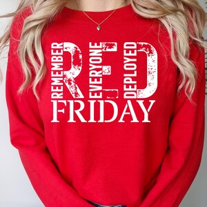 May include: Red sweatshirt with white text that reads "Remember Everyone Deployed Red Friday".