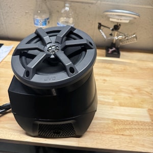 May include: A black JVC speaker with a round, black speaker grille and a black, textured base.